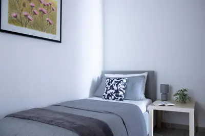 a bedroom with a bed and a side table at Tommys flat by DomusDimore in Rome