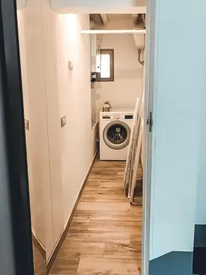 a hallway leading to a laundry room with a washer and dryer at Torretta Luxury Attico in Rome