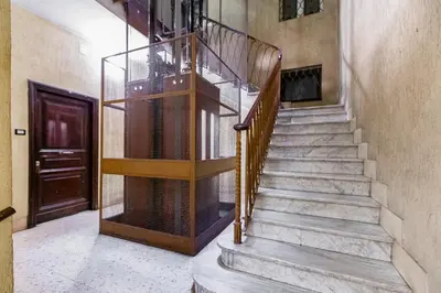 a staircase in a house with a bird cage at InTheMoodForRome - Musei Vaticani in Rome