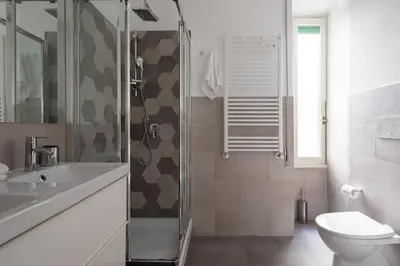 a bathroom with a shower and a toilet and a sink at Nice and spacious apartment near the Vatican and Starbucks in Rome