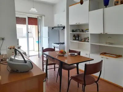 a kitchen with a table and chairs and a dining room at Conca d'Oro 212 in Rome