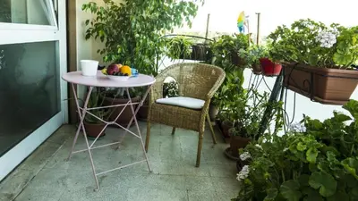 a small table and chairs on a balcony with plants at Conca d'Oro 212 in Rome