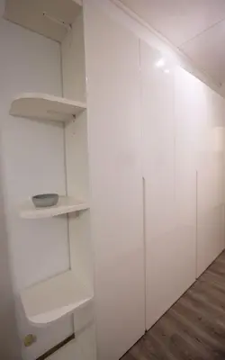 a walk in closet with white cabinets and wood floors at Domus Collazia - San Giovanni Apartment in Rome