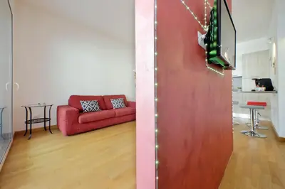 a living room with a red couch and a table at Claudias flat by DomusDimore in Rome