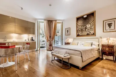 a bedroom with a large bed and a kitchen at The Terrace Luxury in Rome