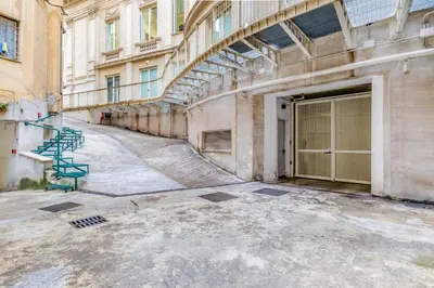 an empty alley with a building with a garage at The Terrace Luxury in Rome