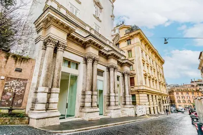 a large building with columns on a city street at The Terrace Luxury in Rome