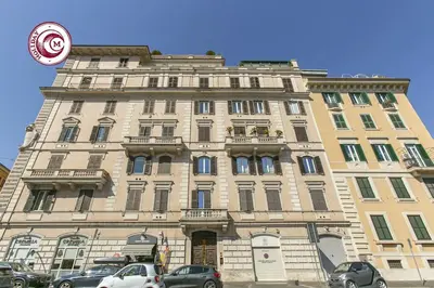 a large building with cars parked in front of it at C M Civitas Leonina Luxury in Rome