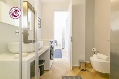 a white bathroom with a sink and a mirror at C M Il Passetto di Borgo Pio in Rome