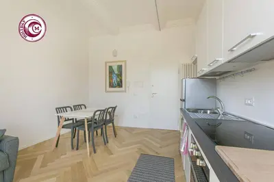a kitchen and dining room with a table and chairs at C M Il Passetto di Borgo Pio in Rome