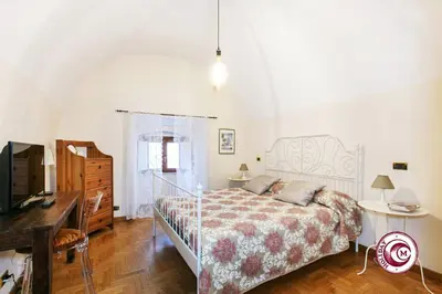 a bedroom with a bed and a desk and a television at Palazzo Scapucci Apartment a Navona in Rome