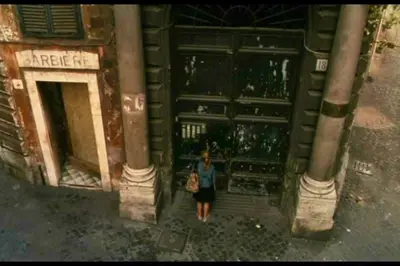 a woman standing in front of a building at Palazzo Scapucci Apartment a Navona in Rome