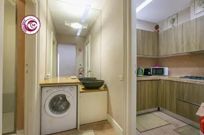 a laundry room with a washing machine in a kitchen at C M Piazza Cavour Elegant Flat in Rome