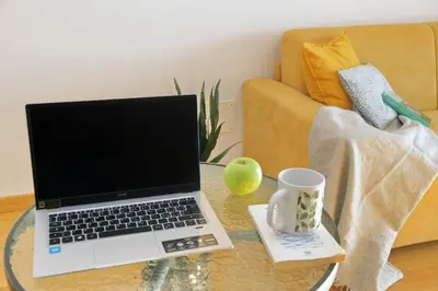 a laptop on a glass table in a living room at Martas flat by DomusDimore in Rome