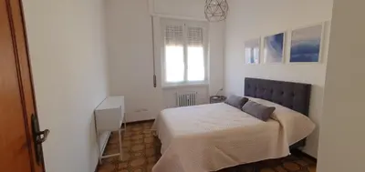 a bedroom with a bed and a window at Attico a Gianicolense in Rome
