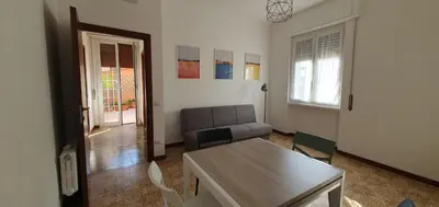 a living room with a couch and a table at Attico a Gianicolense in Rome