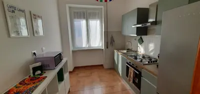 a kitchen with a sink and a stove top oven at Attico a Gianicolense in Rome