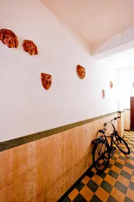 a bike parked next to a wall with animal heads on it at Mario Suite Spagna in Rome