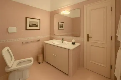a bathroom with a toilet and a sink and a mirror at Femi apartments in Rome