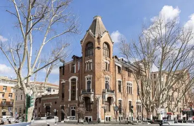 a large brick building with a tower on top of it at Femi apartments in Rome