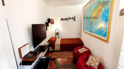 a small bedroom with a bed and a chair at La Dolce Vita in Rome