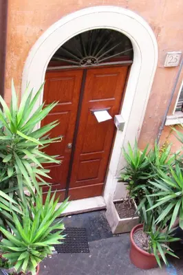 a wooden door with plants in front of it at Santonofrio Apartments in Rome