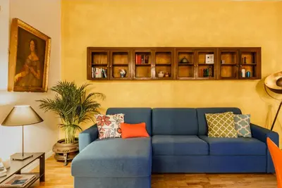 a living room with a blue couch in a room at Santonofrio Apartments in Rome