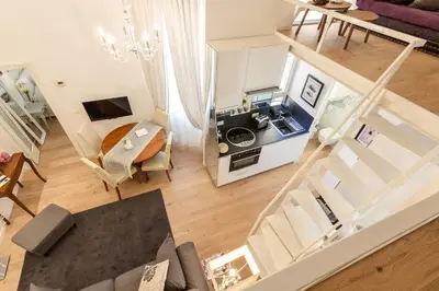 an overhead view of a living room and kitchen in a apartment at La Casa Di Teo in Rome