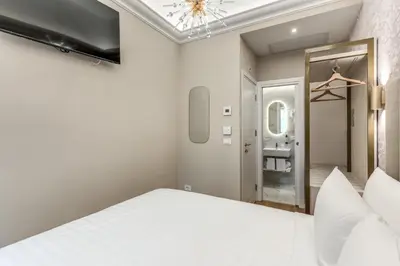 a bedroom with a white bed and a mirror at Lumi Hotel in Rome