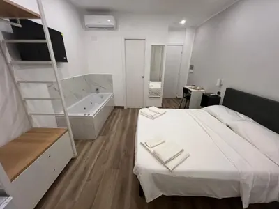 a bedroom with a bed and a bath tub at Suite 98 in Rome