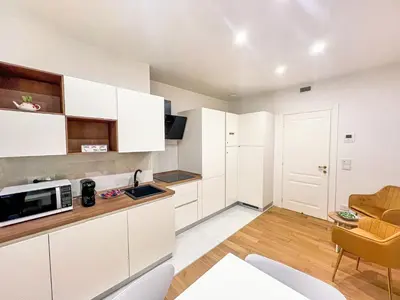 a kitchen with white cabinets and a microwave at Coppedè Lovely Apartment in Rome