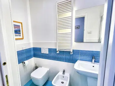 a bathroom with a sink and a toilet and a mirror at Coppedè Lovely Apartment in Rome