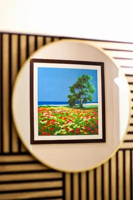 a picture of a field of flowers with a tree at Coppedè Lovely Apartment in Rome