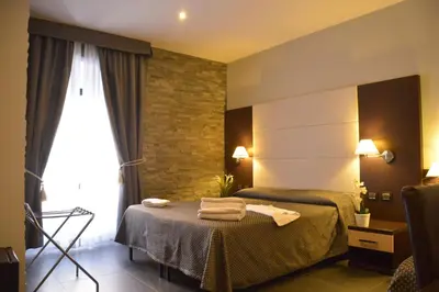 a hotel room with a bed with towels on it at Beautiful Colosseum Roma in Rome