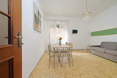 a living room with a table and chairs and a couch at Golden Apartment in Rome
