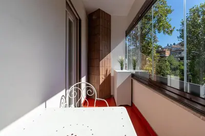 a balcony with a white bench and a large window at Apartment Valle Aurelia Metro in Rome