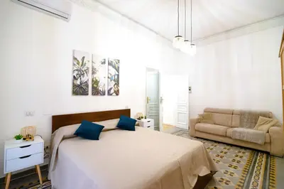 a bedroom with a large bed and a couch at Cozy hideaway in Trastevere in Rome