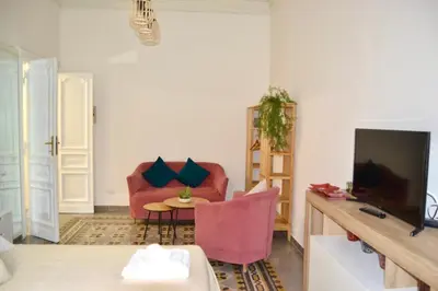 a living room with a red chair and a table at Cozy hideaway in Trastevere in Rome