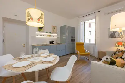 a kitchen and living room with a table and chairs at San Lorenzo Style Apartment in Rome