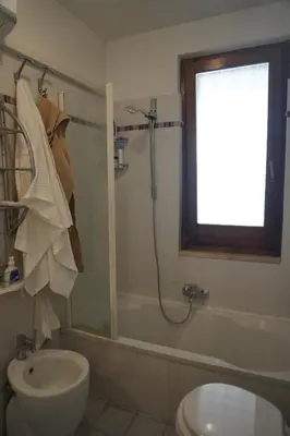 a bathroom with a shower and a toilet and a sink at Stazione Trastevere Apartment in Rome