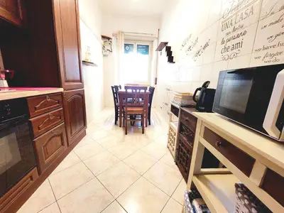 a kitchen with a counter and a table and chairs at Trastevere in Station in Rome