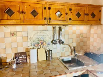 a kitchen counter with a sink and wooden cabinets at Minicasa Vatican in Rome