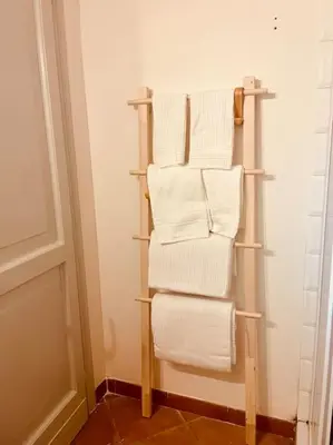 a towel rack in a bathroom with white towels at Minicasa Vatican in Rome