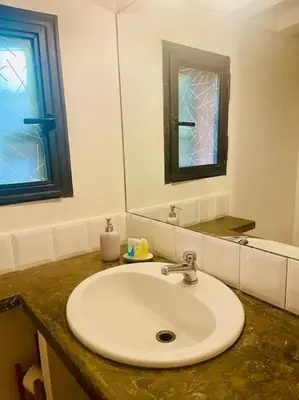a bathroom with a white sink and a mirror at Minicasa Vatican in Rome