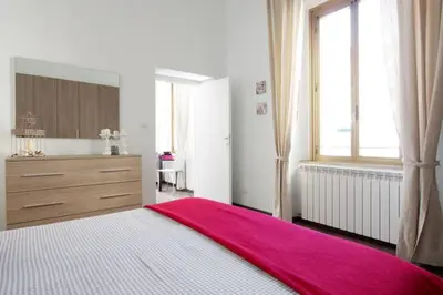 a bedroom with a large bed with a red blanket on it at Testaccio Roma Style Apartment in Rome
