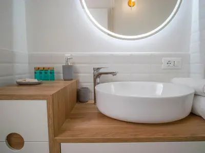 a bathroom with a large white tub on a wooden counter at 2BDR Testaccio Sweet Home in Rome