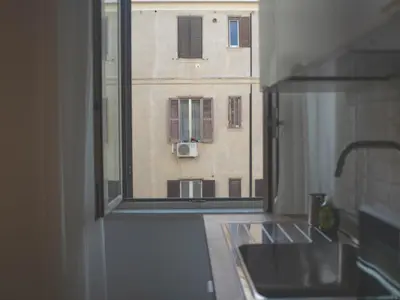 a kitchen window with a view of a building at 2BDR Testaccio Sweet Home in Rome