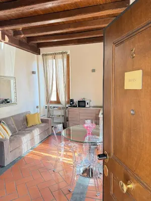 a living room with a couch and a glass table at Casa Navona Apartments in Rome