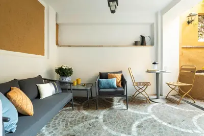 a living room with a couch and a table and chairs at YCH-Belle Epoque House in Rome