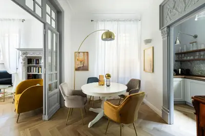 a dining room with a white table and chairs at YCH-Belle Epoque House in Rome